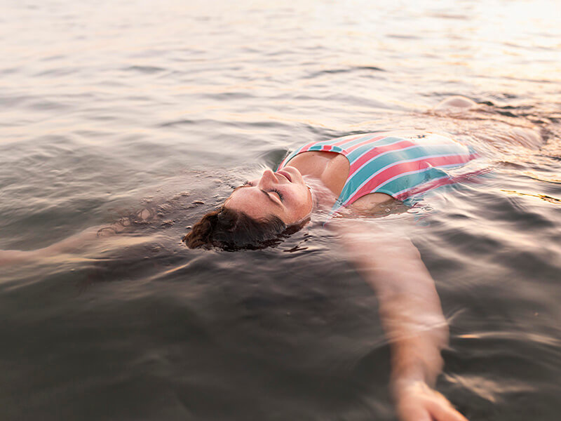 A pregnant woman floating in the sea
