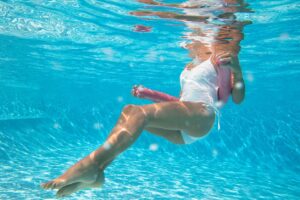 aquagym exercise with a fry: a woman performs an exercise with a fry