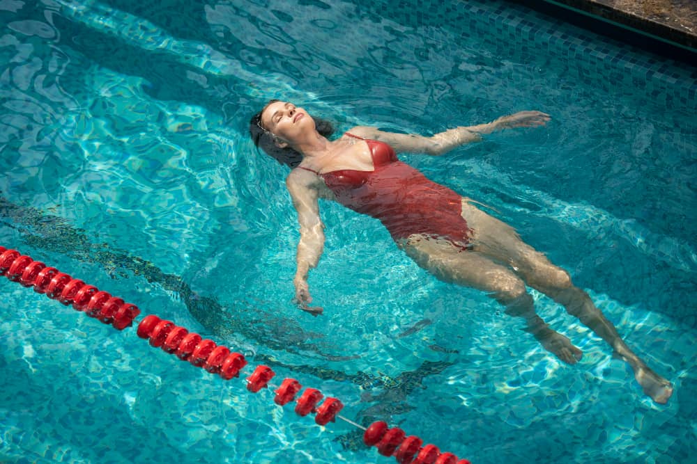 Backstroke aquagym exercise: a woman does a backstroke exercise
